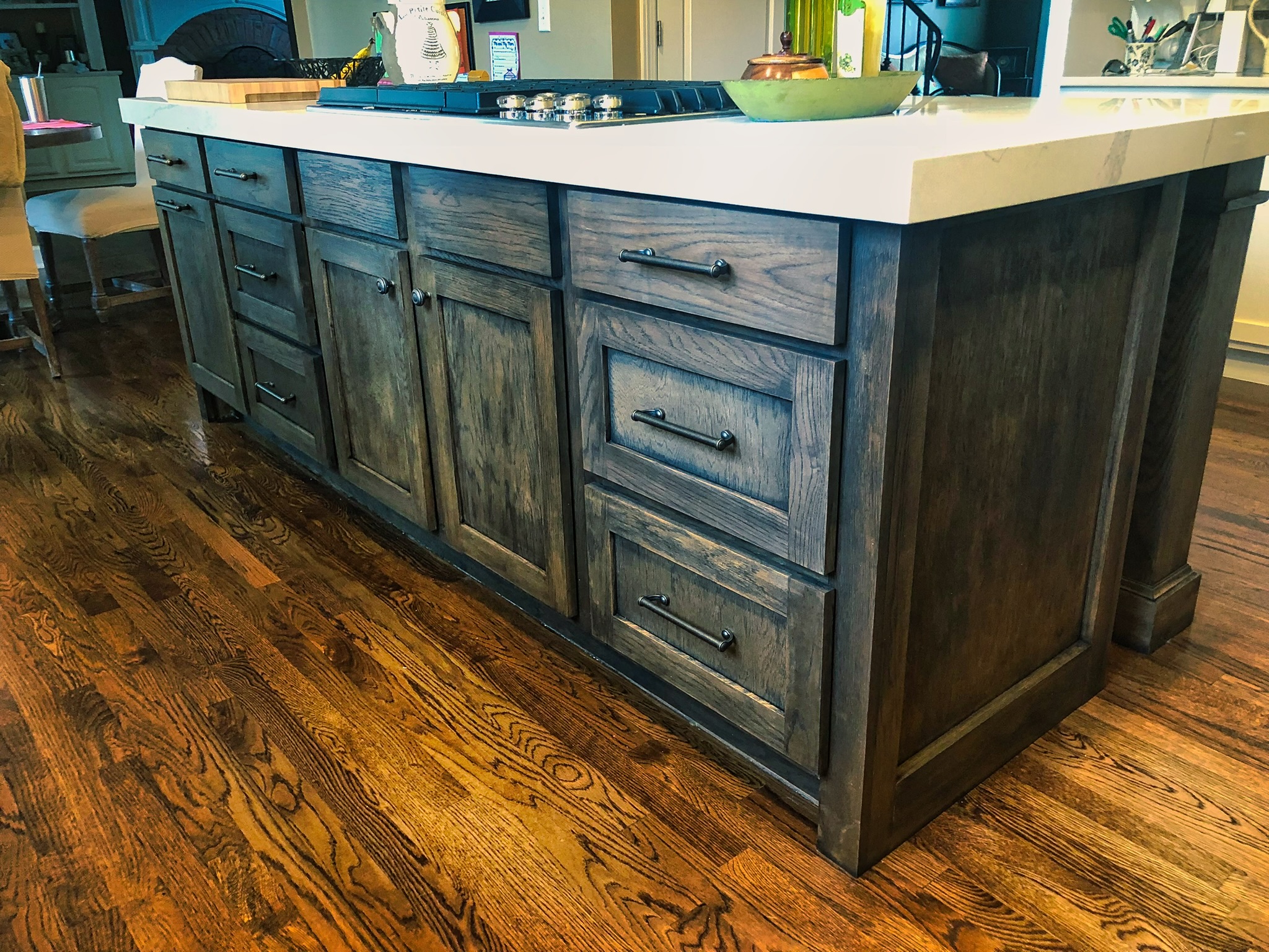 Gray-stained kitchen island with bronze hardware